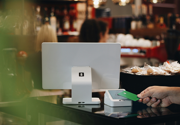 image of a person pauing with card on a computer